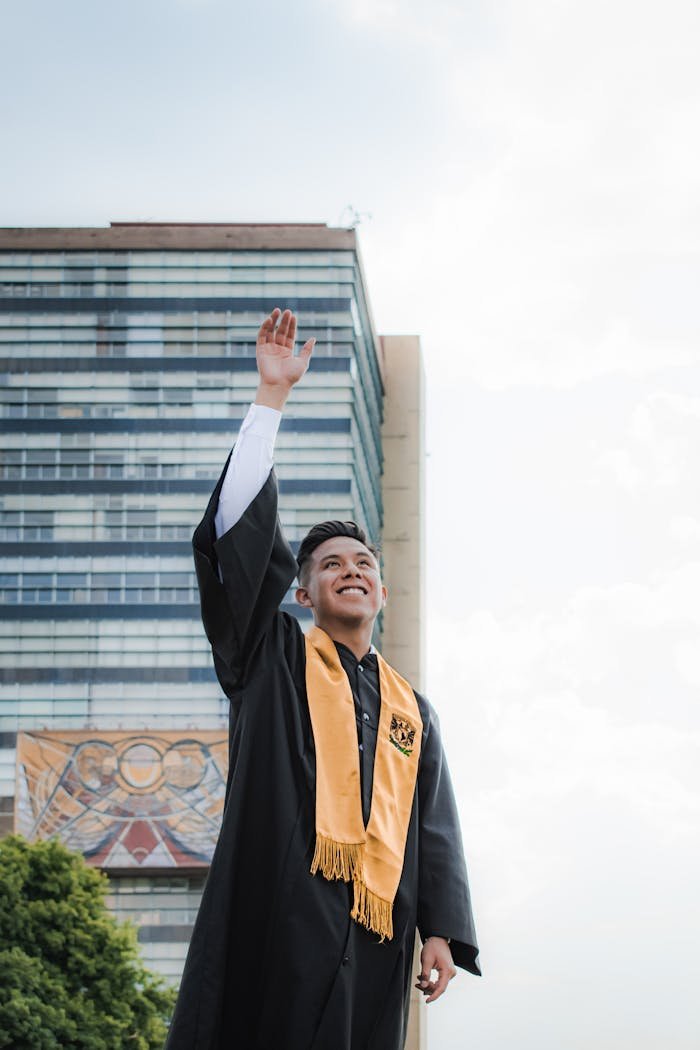 Smiling Graduate with Arm Raised